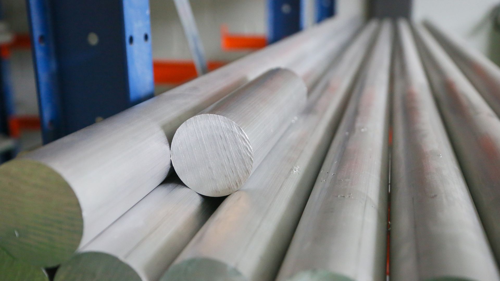 Aluminium round bar stock stacked in a rack.