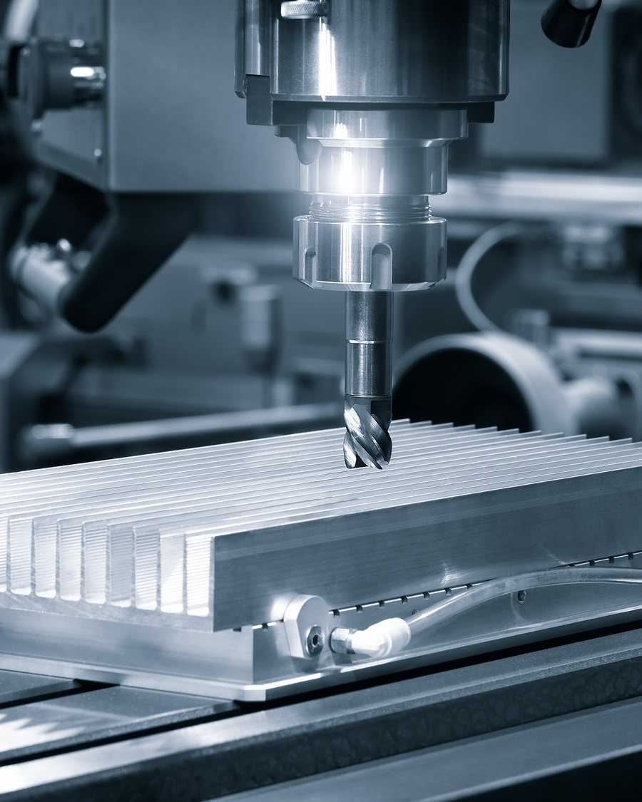 An end mill cutting a slotted aluminium block.
