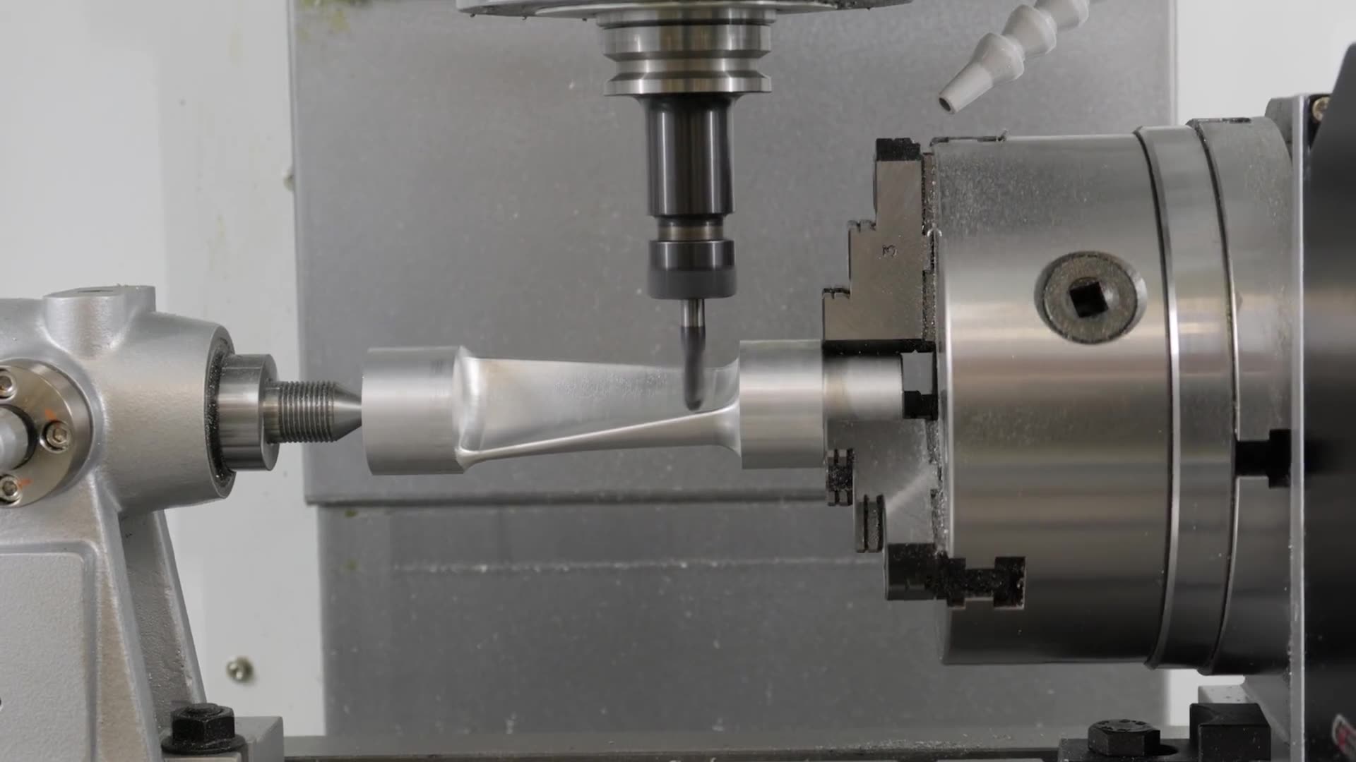 A CNC machining centre boring a steel component.