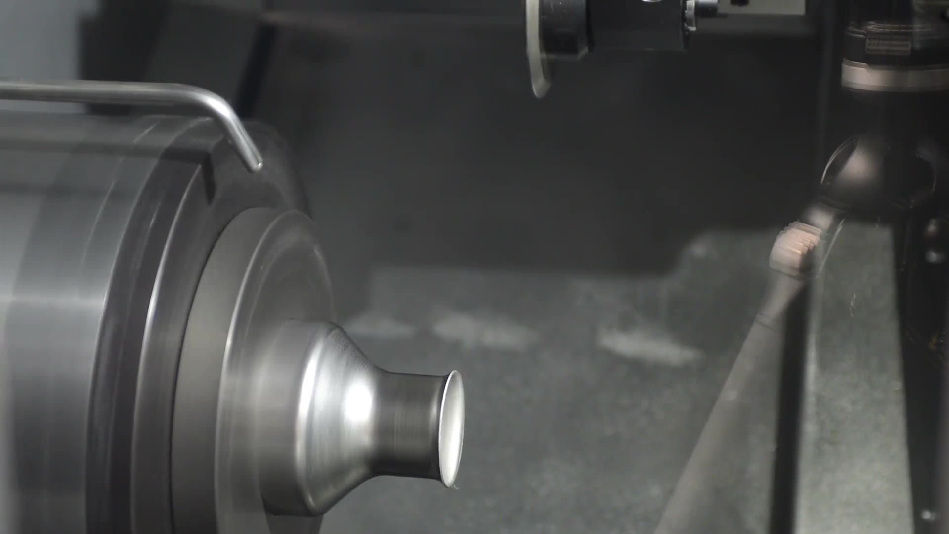 A machine tool forming a steel component.