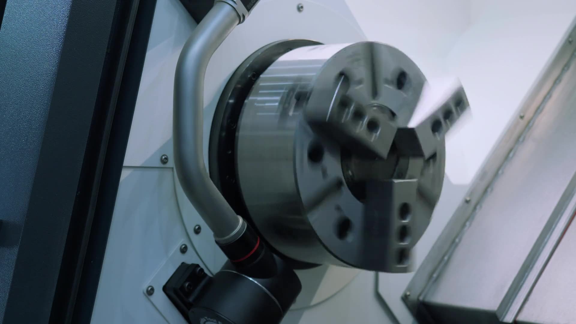 The chuck of a CNC lathe holding a component in operation.